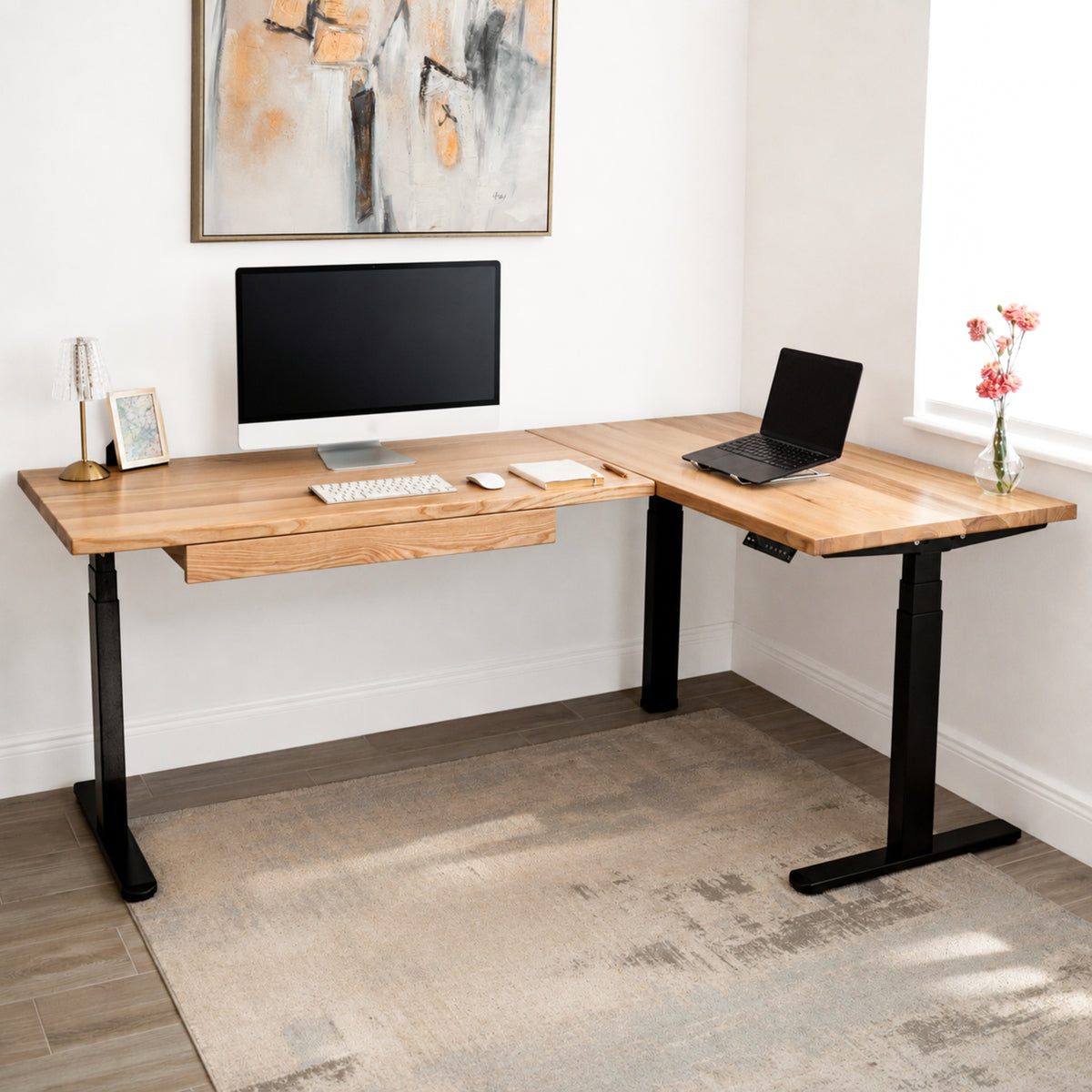 White oak L-shaped standing desk with computer setup in a home office.