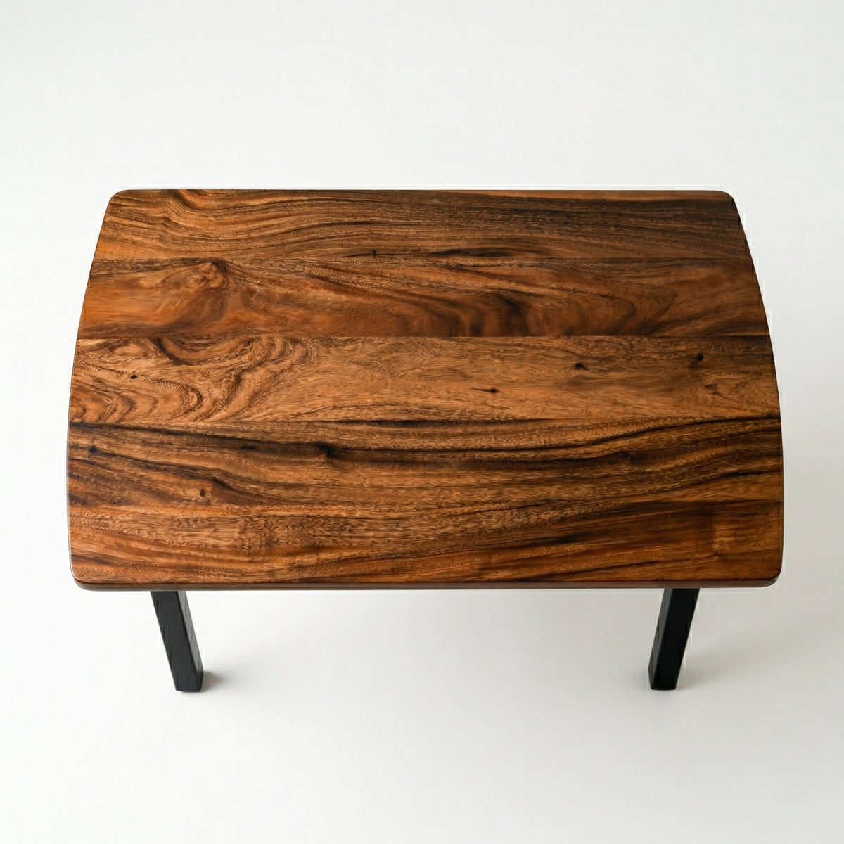 Compact solid walnut dining table with a dark walnut finish on a white background