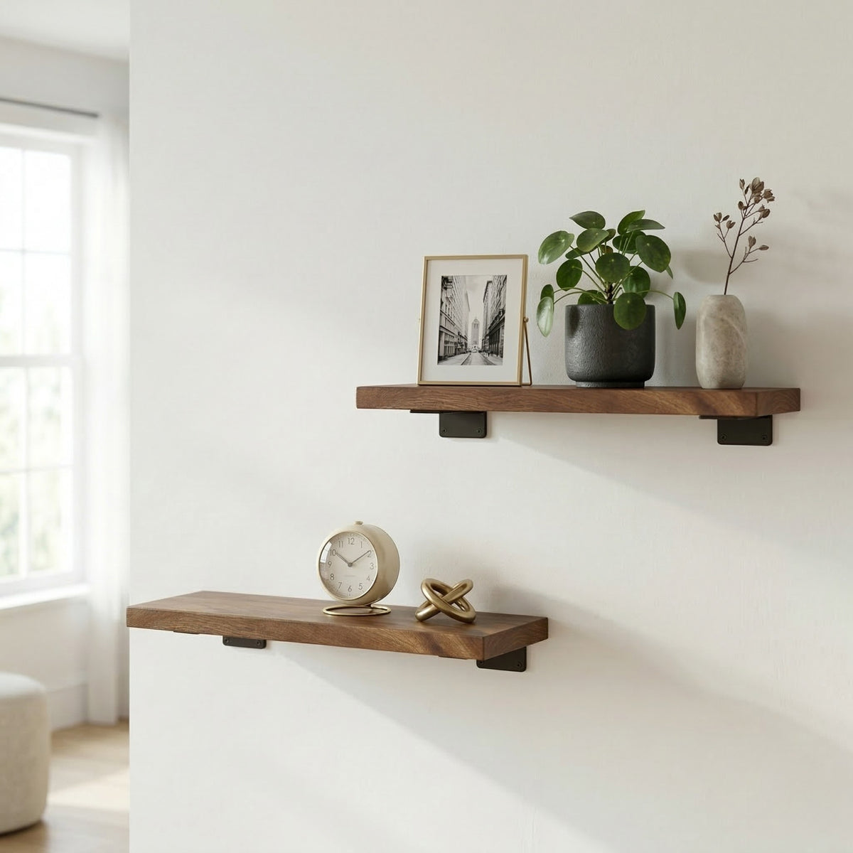Two floating shelves with decorative items on a white wall