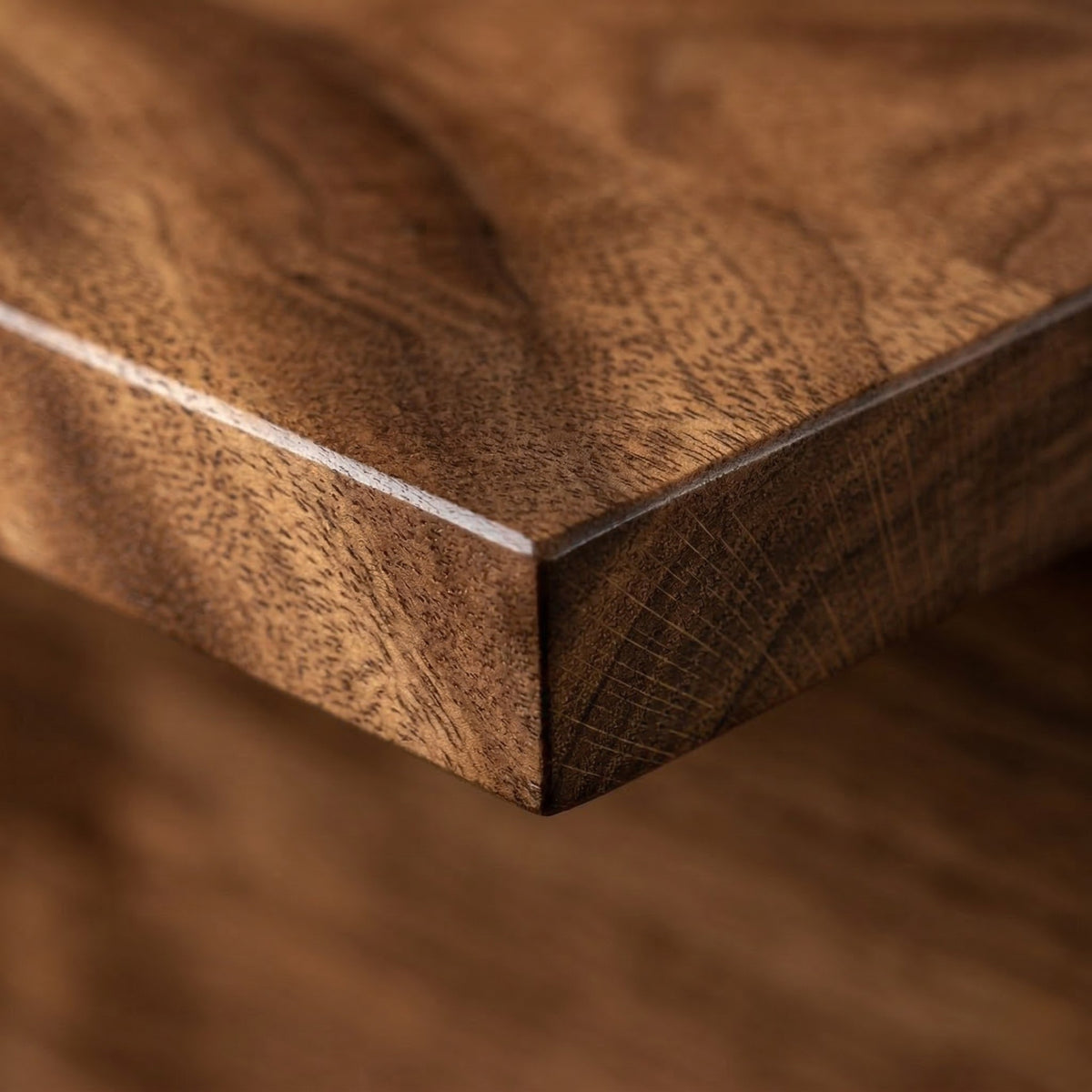 Close-up of a wood shelf with a visible walnut grain pattern