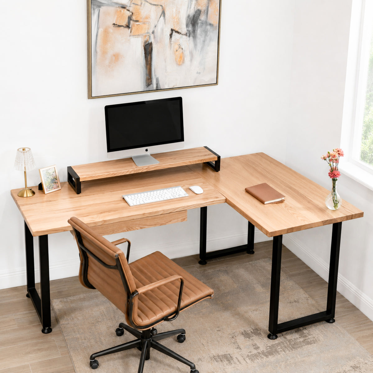 White oak L-shaped desk with drawer, computer monitor, and decor in a home office setting.