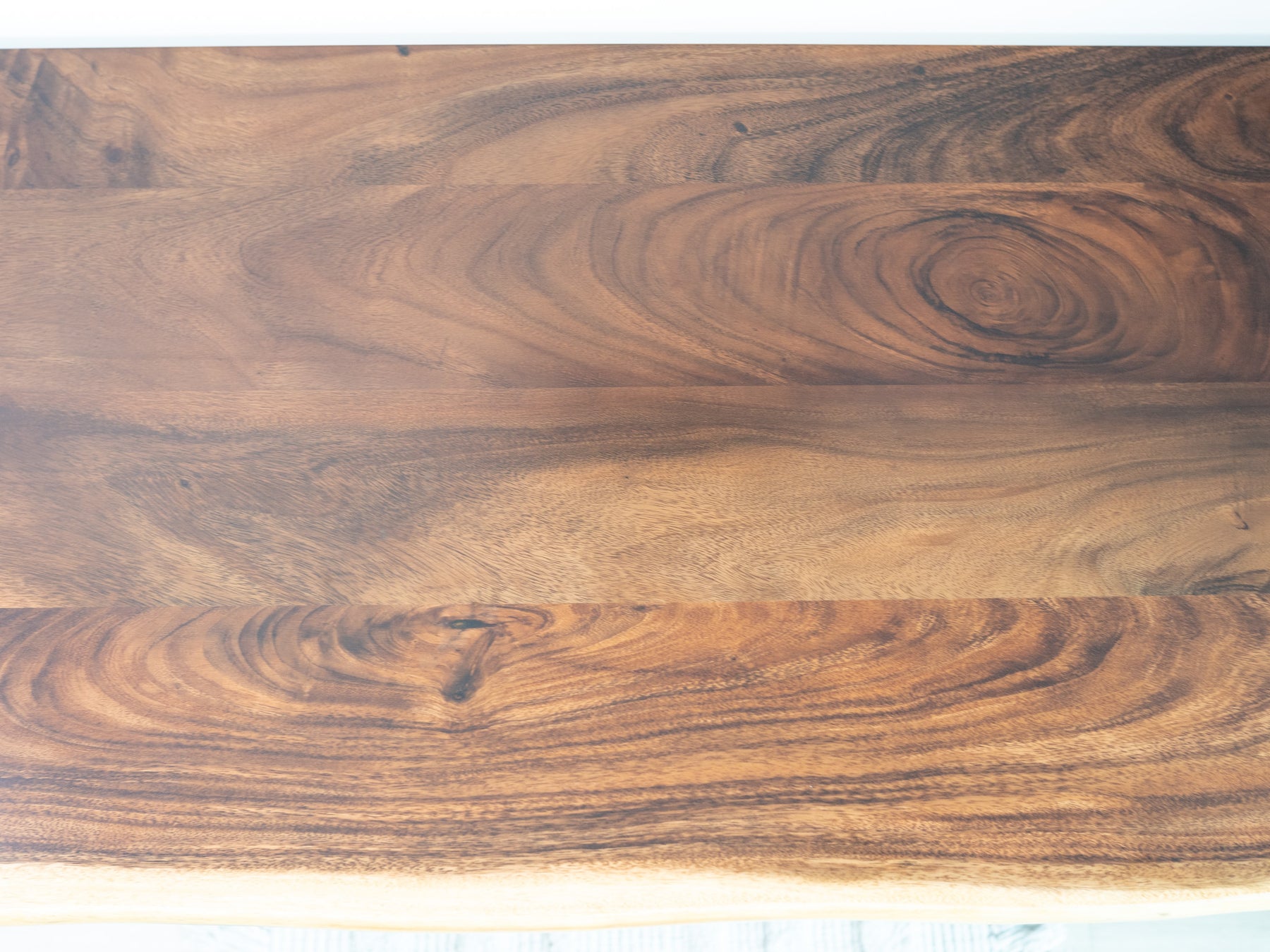 Walnut desktop featuring ergonomic natural live edge and eco-friendly finish in rich walnut brown.