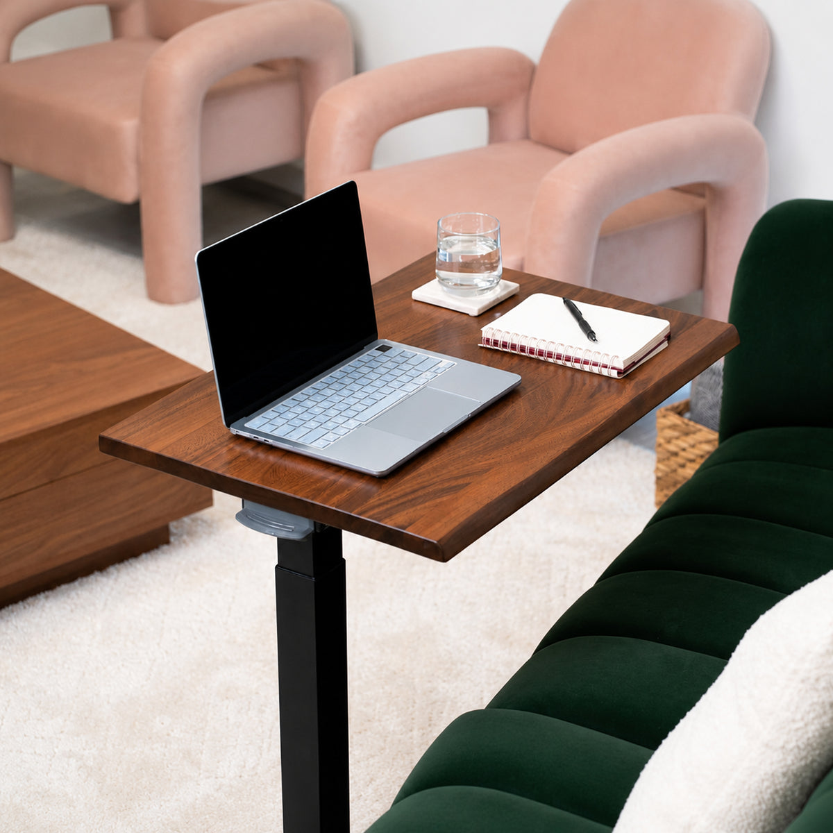Solid walnut rolling laptop desk with live-edge top, black pneumatic frame, and low-profile wheeled base