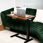 Solid walnut rolling laptop desk with live-edge top, black pneumatic frame, and low-profile wheeled base