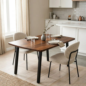 Compact solid walnut dining table and chairs in a modern kitchen setting.