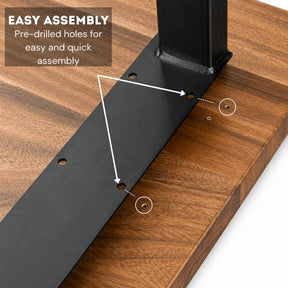 Close-up of a black metal desk leg bracket being attached to a wood desk, with overlaid text reading 'EASY ASSEMBLY' and arrows pointing to pre-drilled holes.