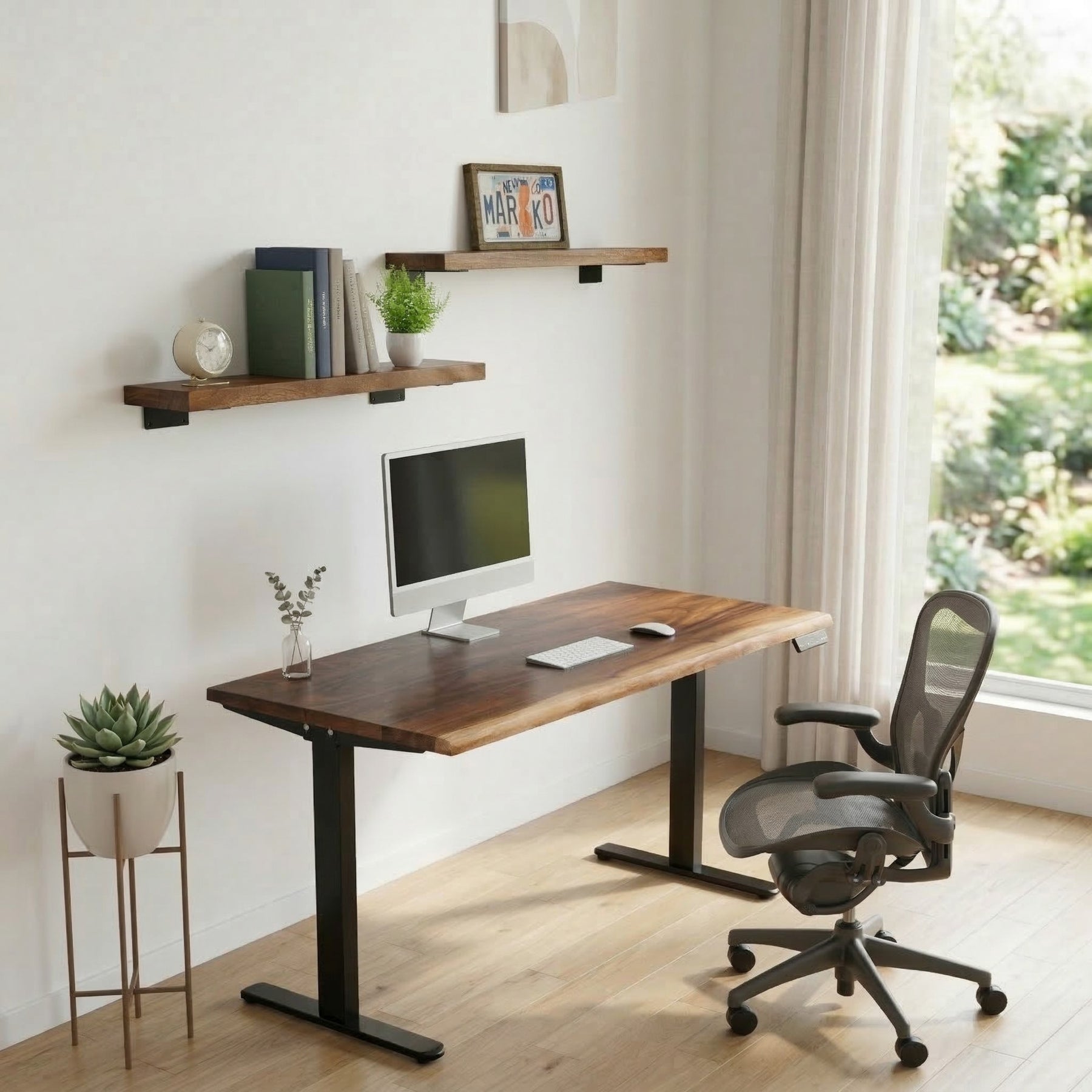 Home office setup with a wooden desk, chair, and walnut floating shelves.
