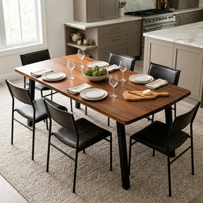 Solid walnut dining table set for a meal, surrounded by black chairs.