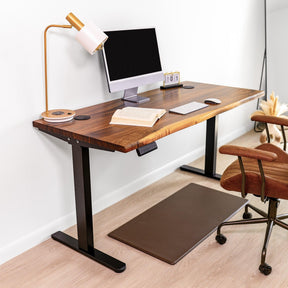 Elegant wood standing desk, ergonomic home office setup, featuring a live edge walnut desktop, modern black frame, and sleek accessories.