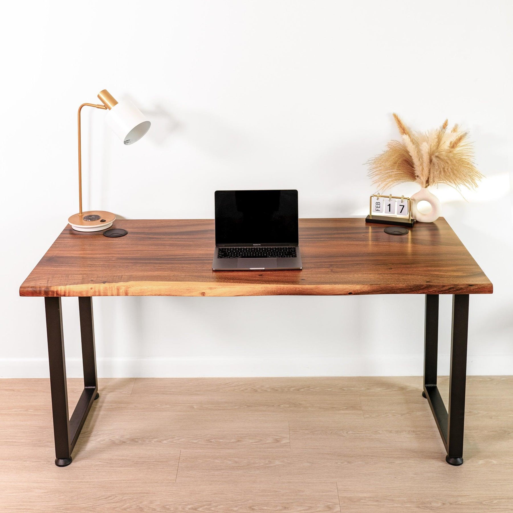 Minimalist setup of a walnut solid wood computer desk with live edge design, featuring a laptop, modern desk lamp, and stylish decor, ideal for a contemporary home office.