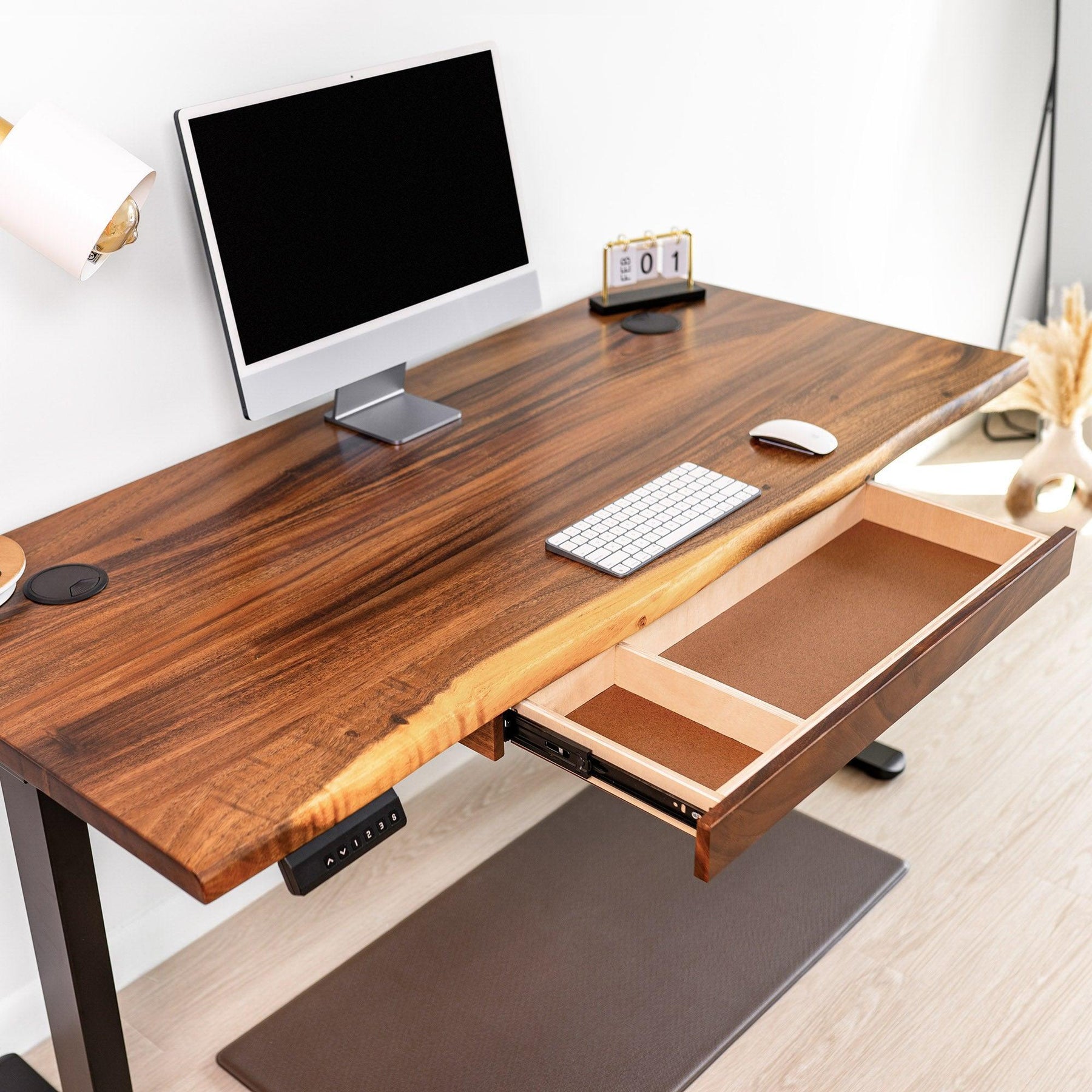 60 inch standing desk with open drawer, featuring an ergonomic design, black adjustable frame, and modern home office setup.