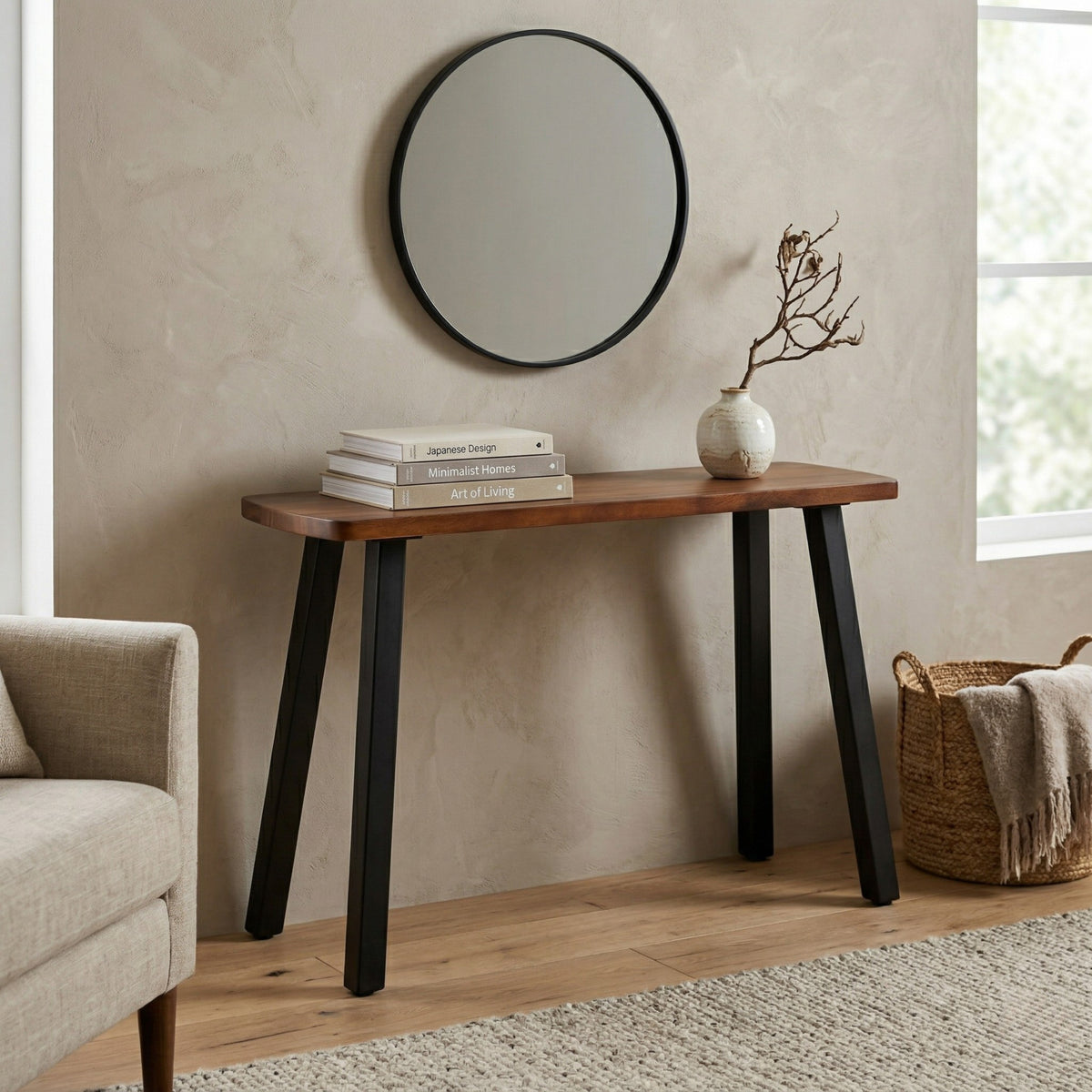 Solid walnut console table with black legs against a beige wall, featuring a mirror above and decor items on top.