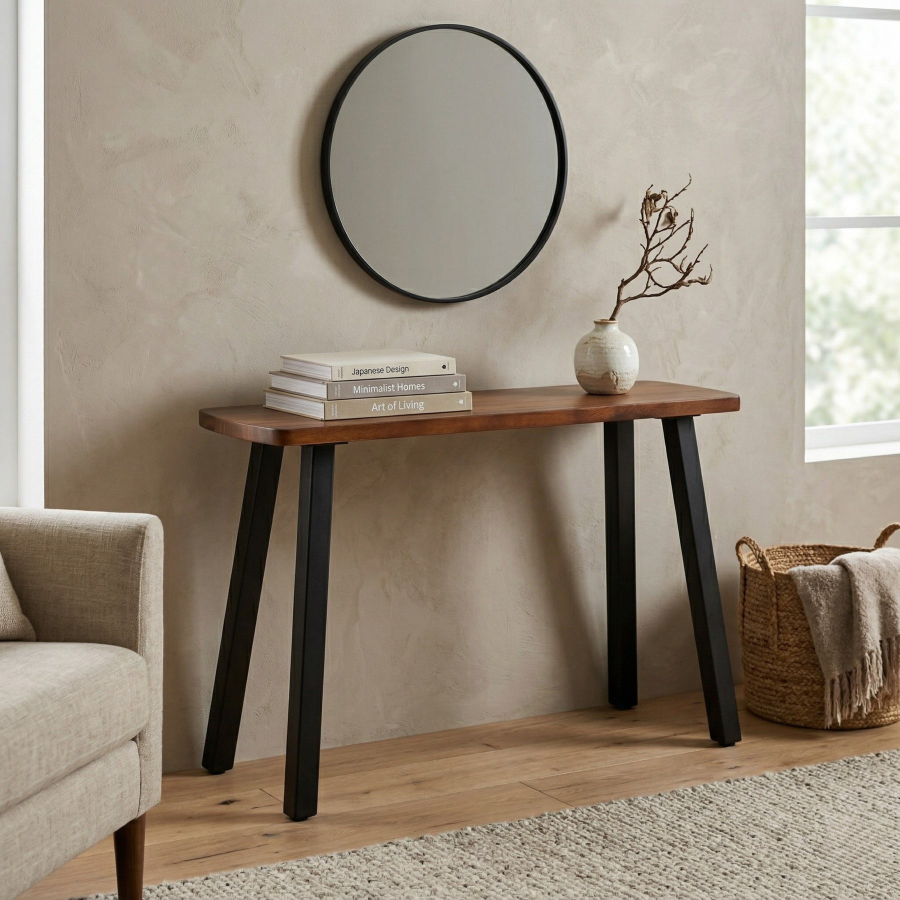 Solid walnut console table with black legs against a beige wall, featuring a mirror above and decor items on top.