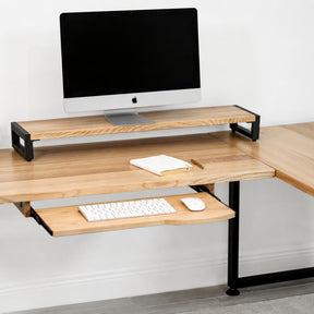 White oak L-shaped desk with keyboard tray, computer setup on a white background