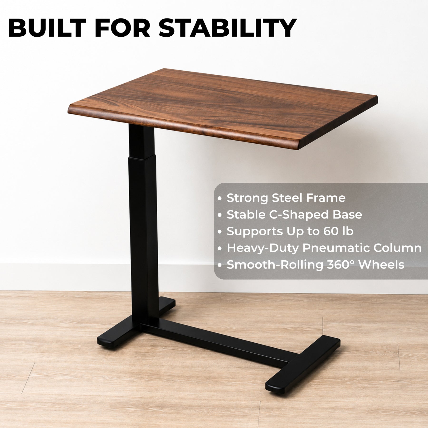 Solid walnut pneumatic standing desk with a steel C-shaped frame, 60-pound capacity, and smooth-rolling wheels