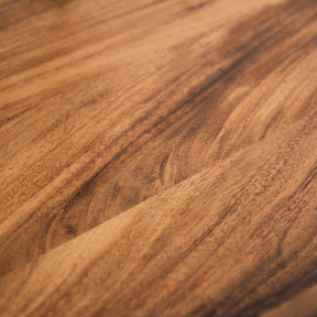 Close-up of a walnut desk with a warm brown color.