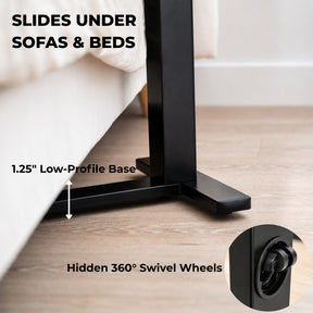 Low-profile rolling desk base sliding under a sofa with hidden 360-degree swivel wheels