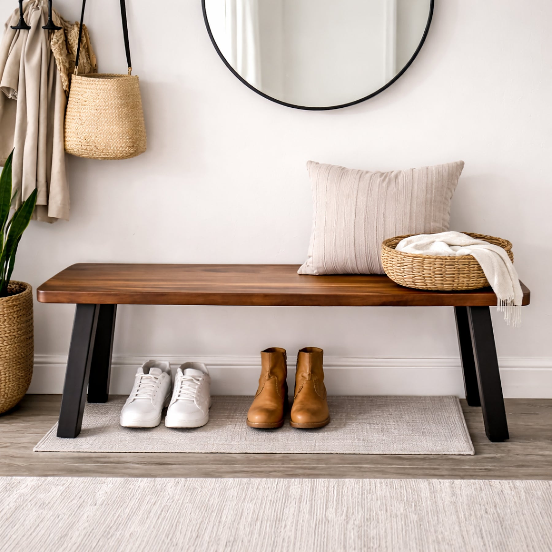 A walnut bench in a hallway with shoes, a pillow, and a basket.