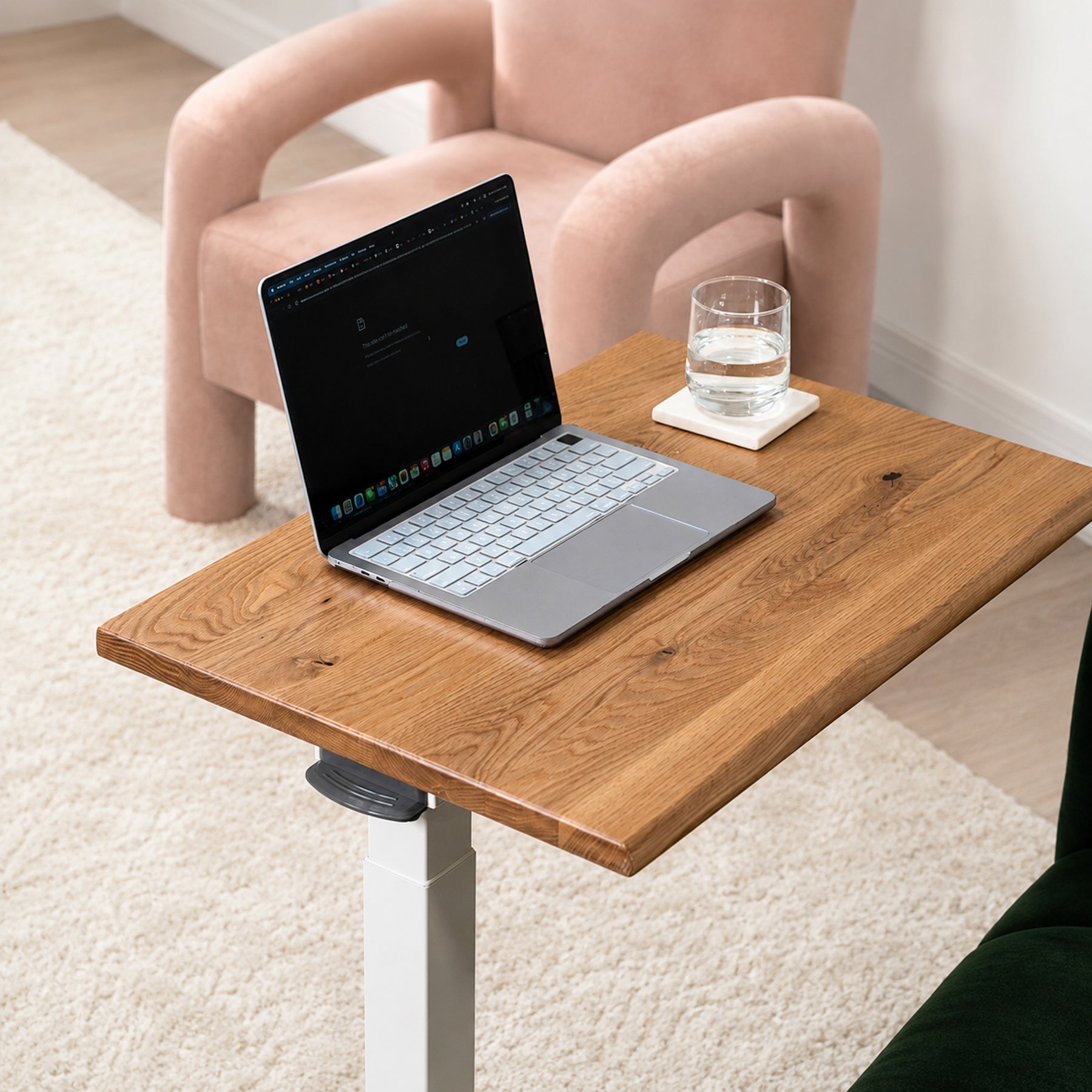 Solid white oak mobile laptop desk with natural live-edge top, white pneumatic frame, and rolling base