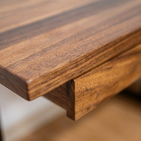 Close-up of a Solid wood L-shaped desk with a blurred background
