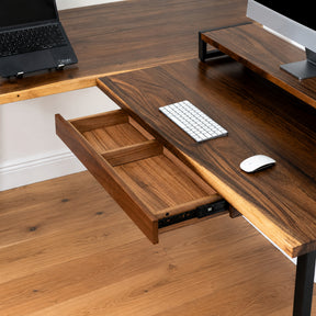 Walnut solid wood L-shaped desk with a drawer and mouse on a wooden floor.