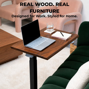 Solid wood rolling laptop desk with live-edge walnut top styled as a compact living room workspace