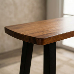 Wooden console table with a walnut finish on a neutral background