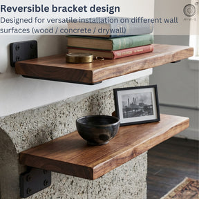 Wooden wall shelves with reversible bracket design on a concrete wall.