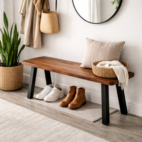 Walnut entryway bench in a hallway with shoes, a plant, and a mirror.