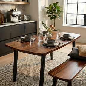Solid walnut dining table with bench, styled with glasses and cutlery in a kitchen.