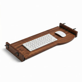 A dark walnut keyboard tray, holding a wireless keyboard and mouse, shown on a clean white background.