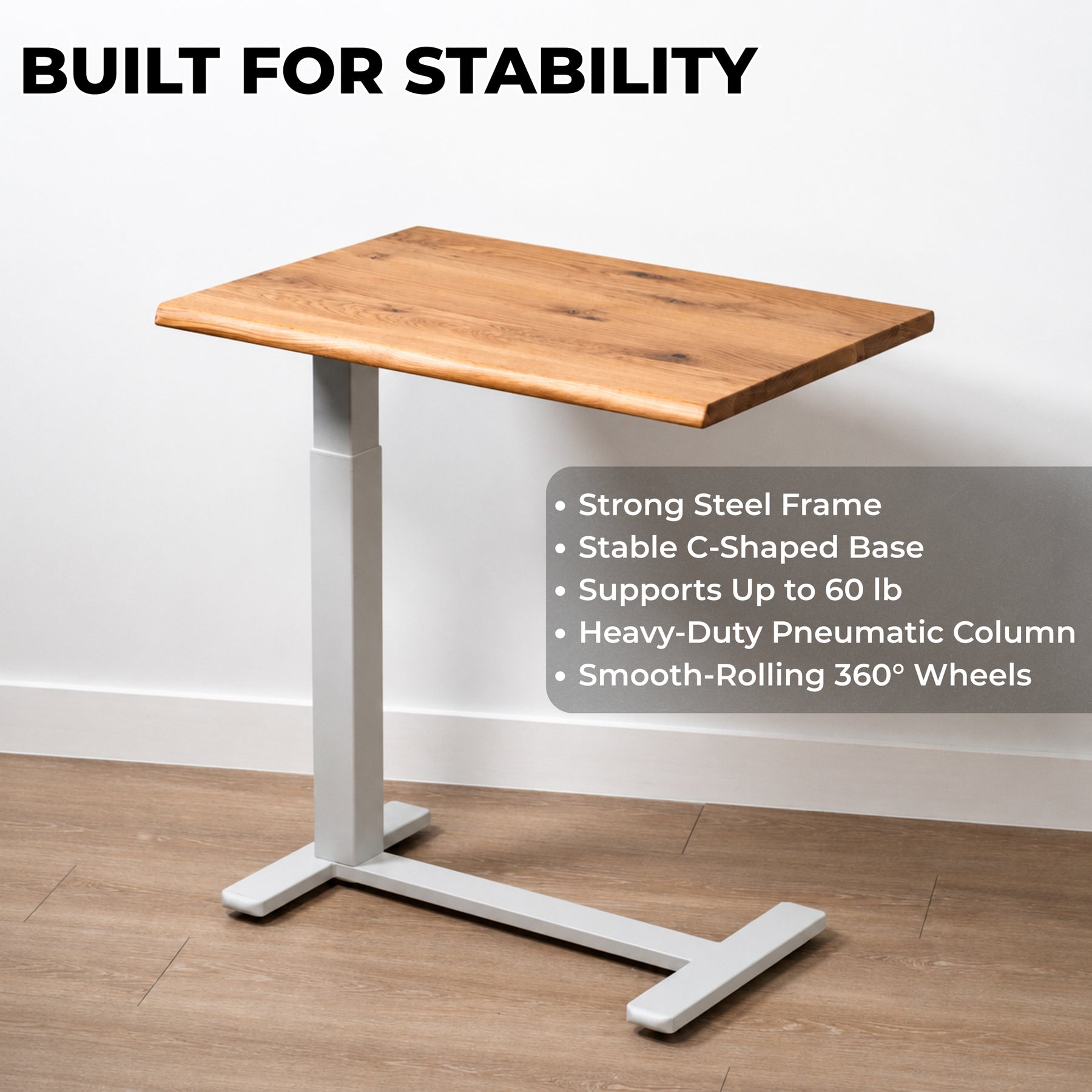 White oak pneumatic standing desk with white steel C-shaped frame, 60-pound capacity, and rolling wheels