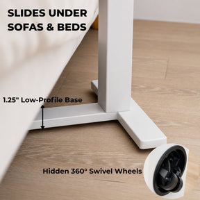 Low-profile white rolling desk base sliding beneath a sofa with hidden 360-degree swivel wheels