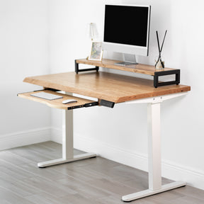 White oak standing desk with keyboard tray, white adjustable height legs in a minimalistic room