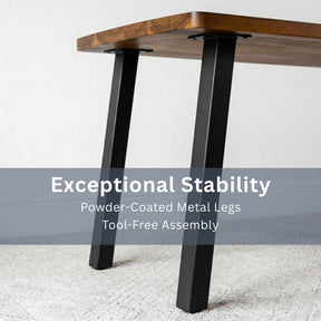 Solid walnut dining table with black powder-coated metal legs on a white background