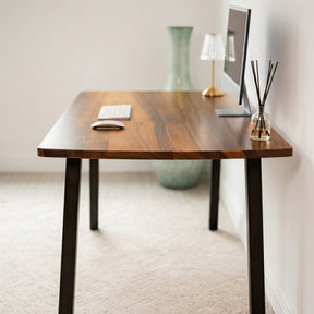 Extra Deep Solid Walnut Computer Desk with a computer monitor, lamp, and decorative items in a minimalistic room.